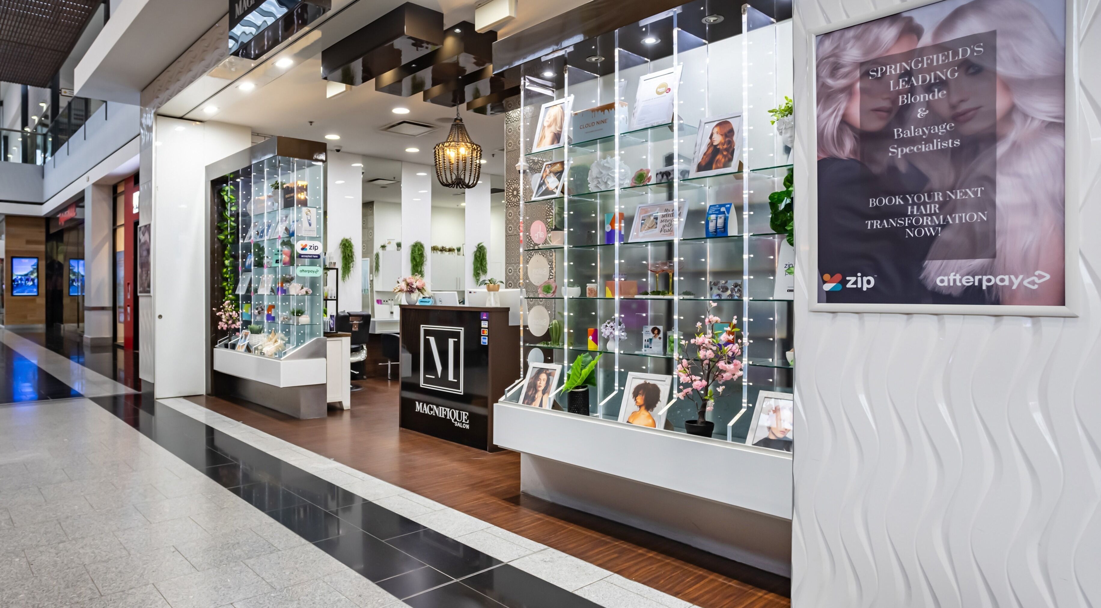 Entrance of Magnifique Salon in Springfield Central, Queensland, AU showcasing stylish interior and display.