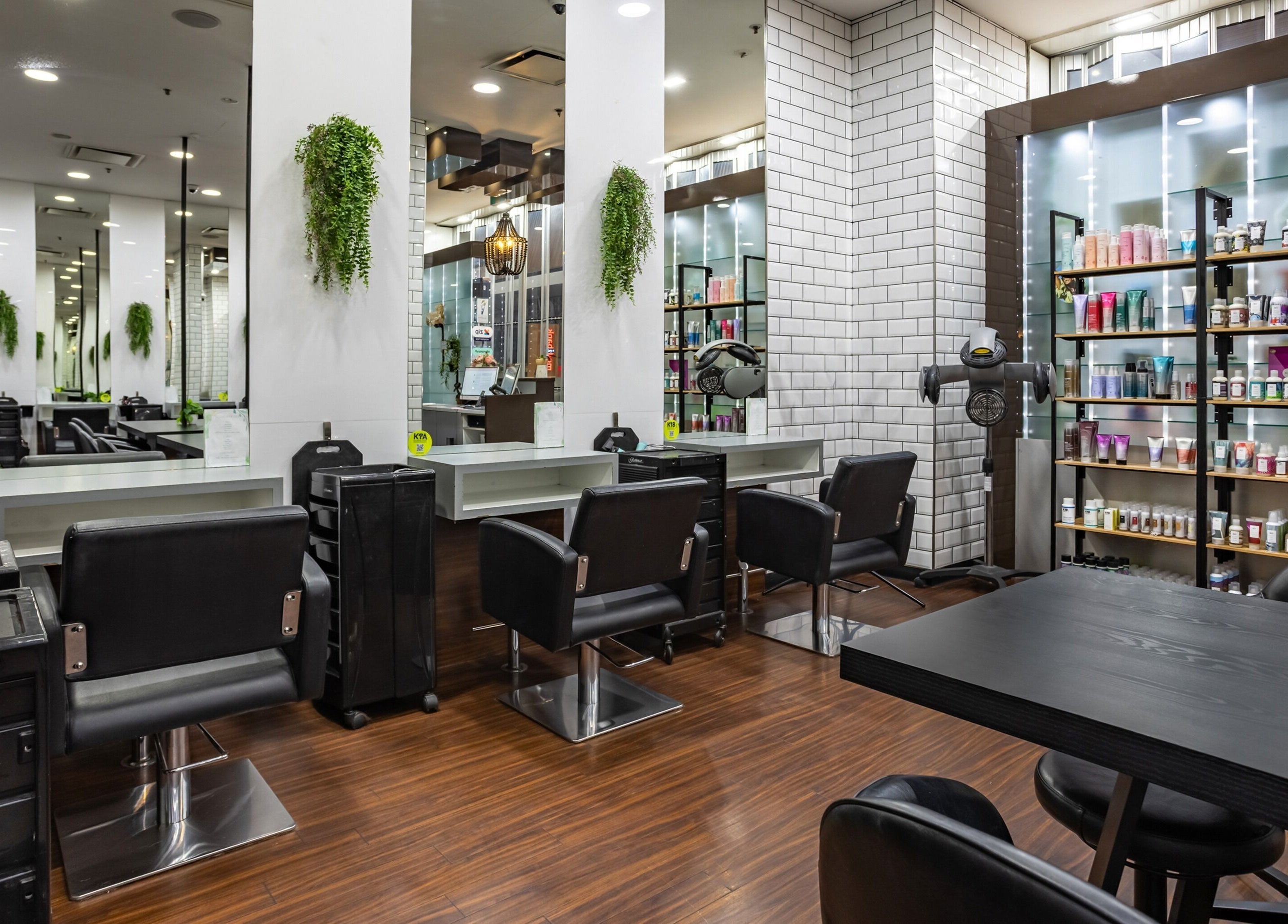 Modern interior of Magnifique Salon at Springfield Central, Queensland, AU, showcasing sleek styling stations.