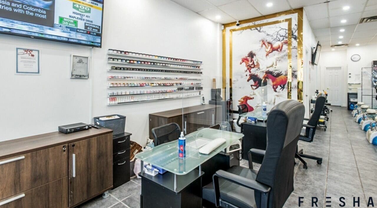 Modern interior of A.T. Nails, Mississauga, Ontario, CA showcasing nail services with sleek design and cozy chairs.