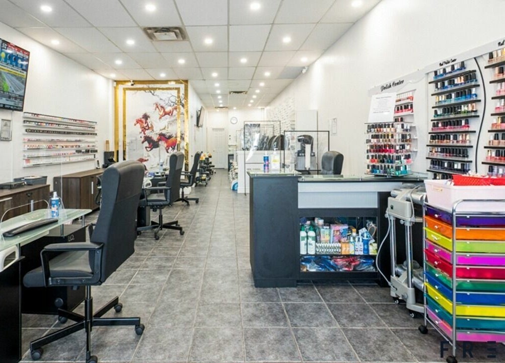 Interior of A.T. Nails salon in Mississauga, Ontario, CA with modern decor and nail polish displays.