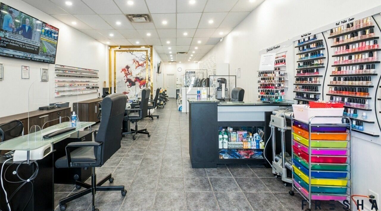 Interior of A.T. Nails salon in Mississauga, Ontario, CA with modern decor and nail polish displays.