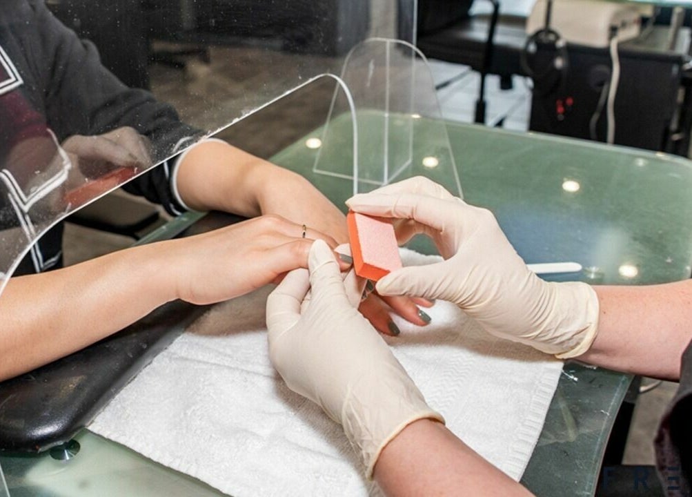 Professional nail buffing at A.T. Nails, Mississauga, Ontario, CA for smooth and polished finish.