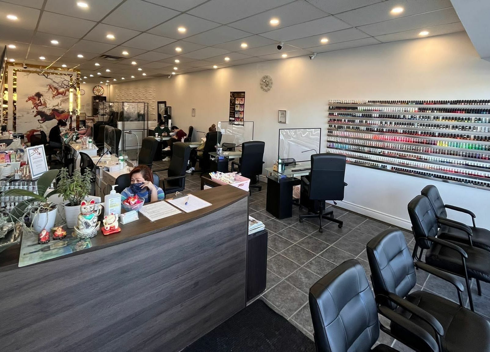 Interior of A.T. Nails in Mississauga, Ontario, CA showcasing a vibrant nail salon with seating and polish selection.