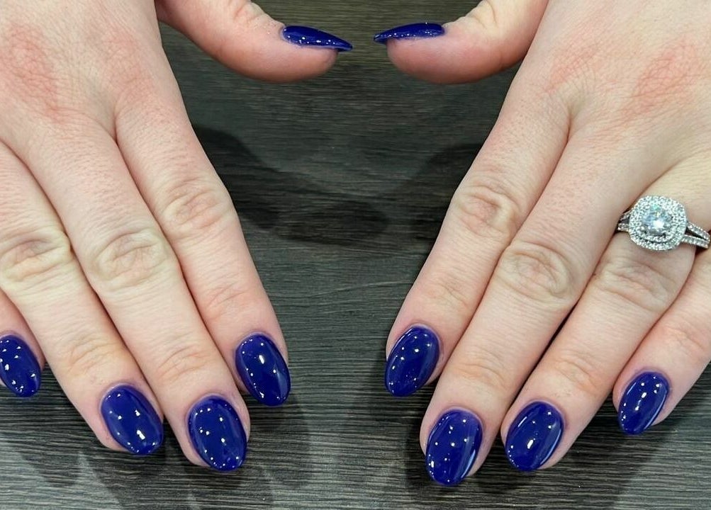 Elegant royal blue nails with a diamond ring at A.T. Nails, Mississauga, Ontario, CA.