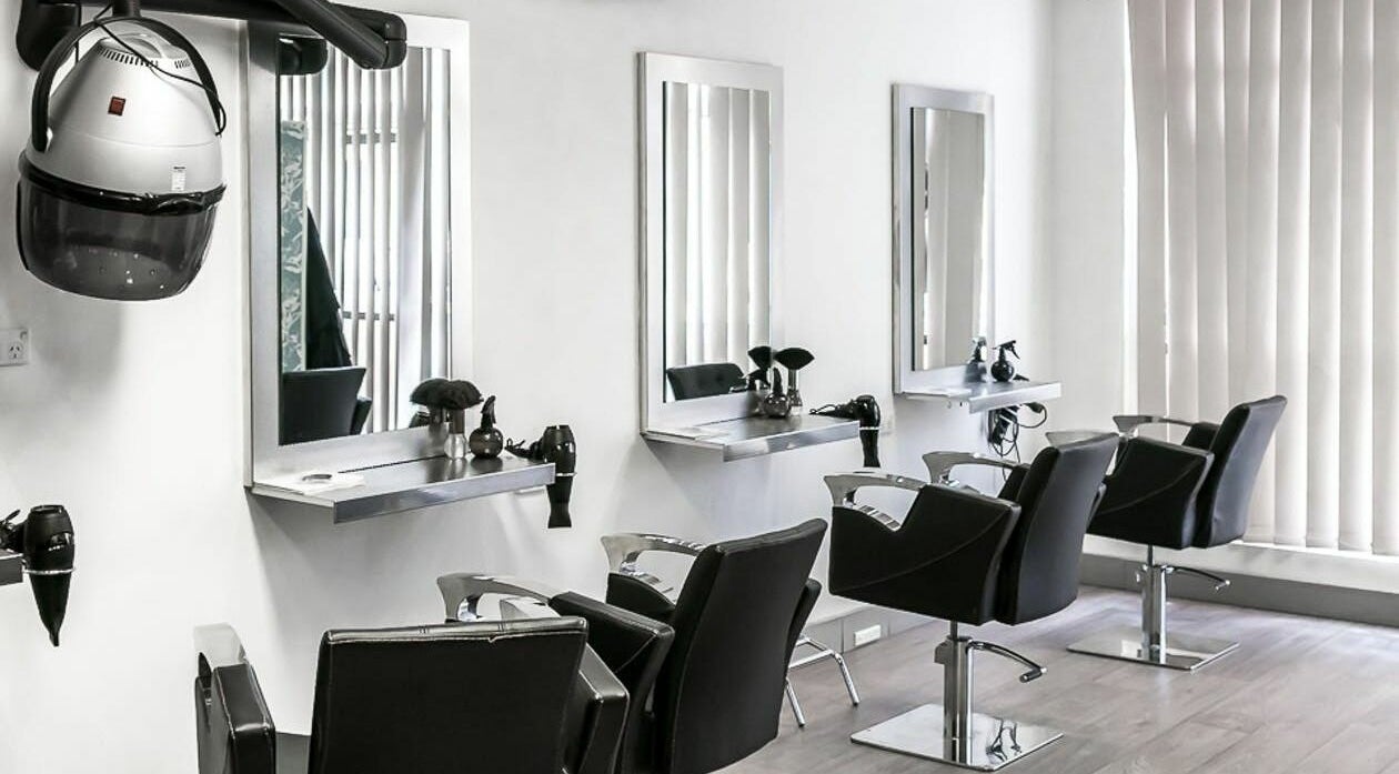 Modern styling stations at Forestville Hairdressing, Forestville, New South Wales, AU feature sleek mirrors.