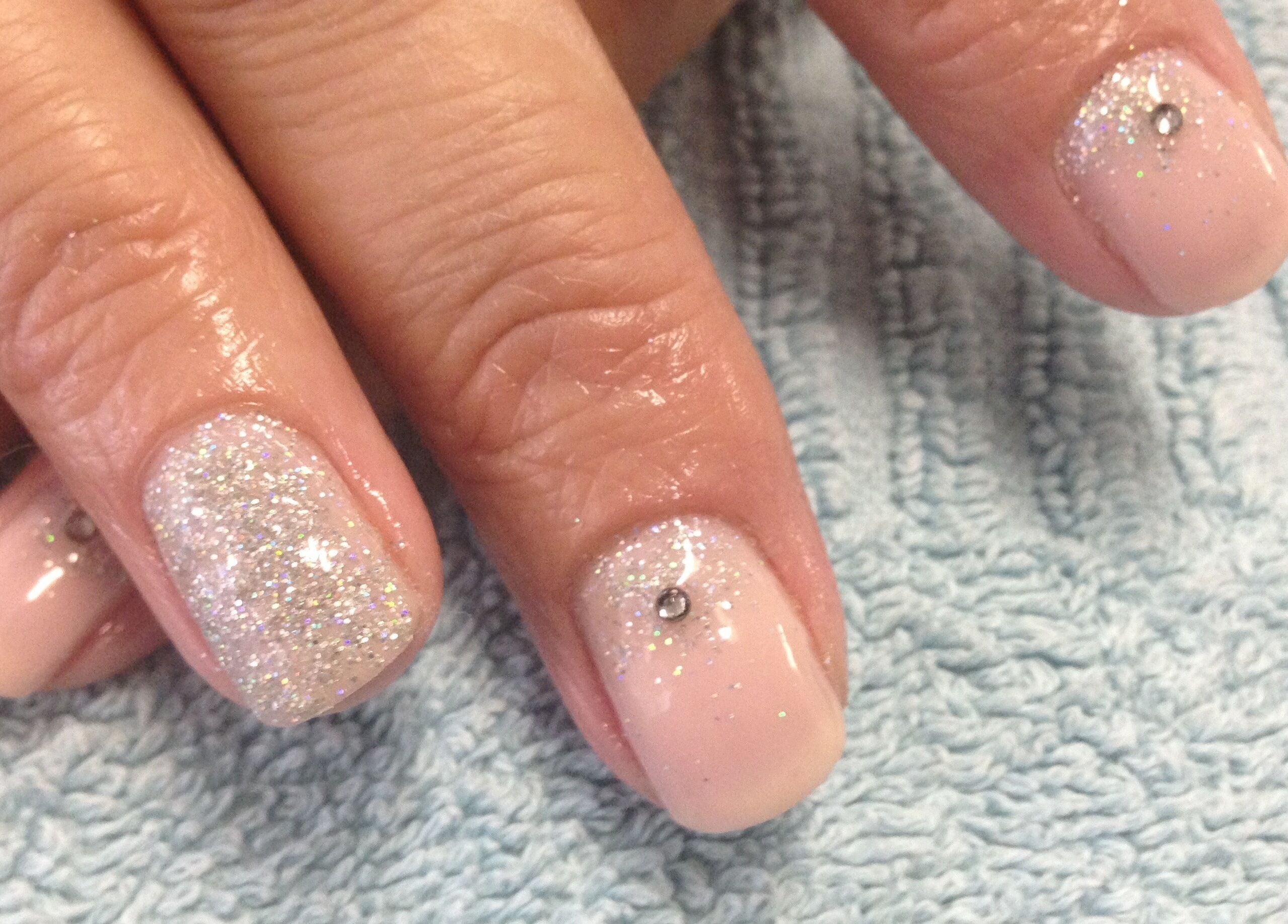 Elegant glittery manicure with rhinestones at Simply BeYoutiful, Cape Town, Western Cape, ZA.