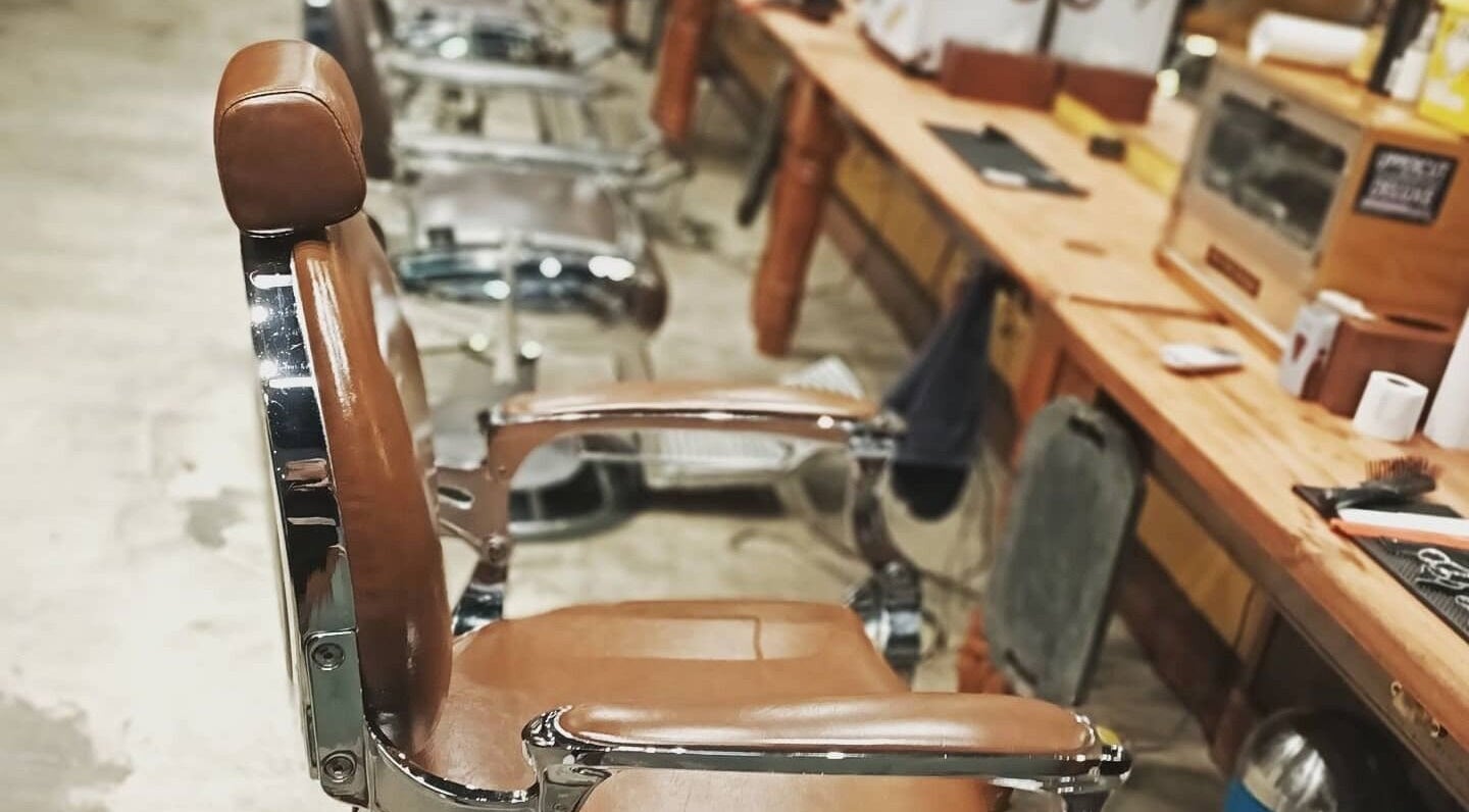 Classic barber chair at Oxbridge Barber Shop, Melbourne, Victoria, AU, highlighting vintage charm and style.