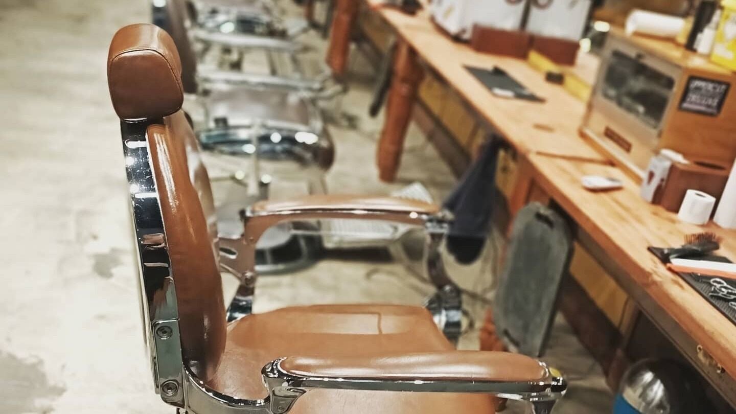 Classic barber chair at Oxbridge Barber Shop, Melbourne, Victoria, AU, highlighting vintage charm and style.