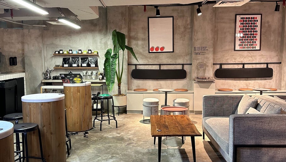 Modern interior of Not a Space, Sharjah, AE with cozy seating, plants, and artistic decor creating an inviting ambiance.