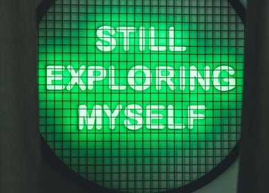Green neon sign saying 'STILL EXPLORING MYSELF' at Not a Space, Sharjah, AE.