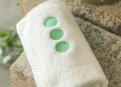 White towel with green dots at Not a Space, Sharjah, AE, offering a calming atmosphere.