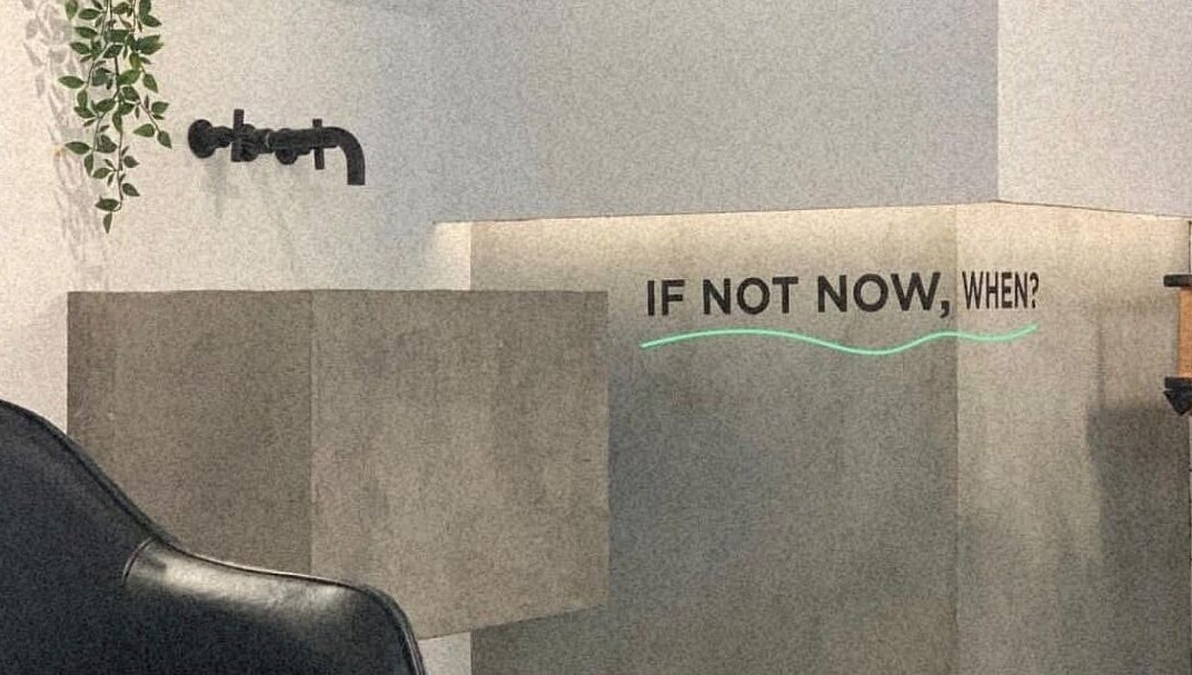 Modern decor at Not a Space, Sharjah, AE with a motivational 'If not now, when?' quote on the wall.