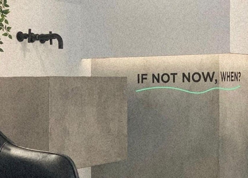 Modern decor at Not a Space, Sharjah, AE with a motivational 'If not now, when?' quote on the wall.