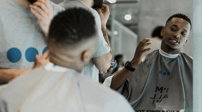 Barber and client engaging at Not a Space, Sharjah, AE, showcasing modern grooming services.