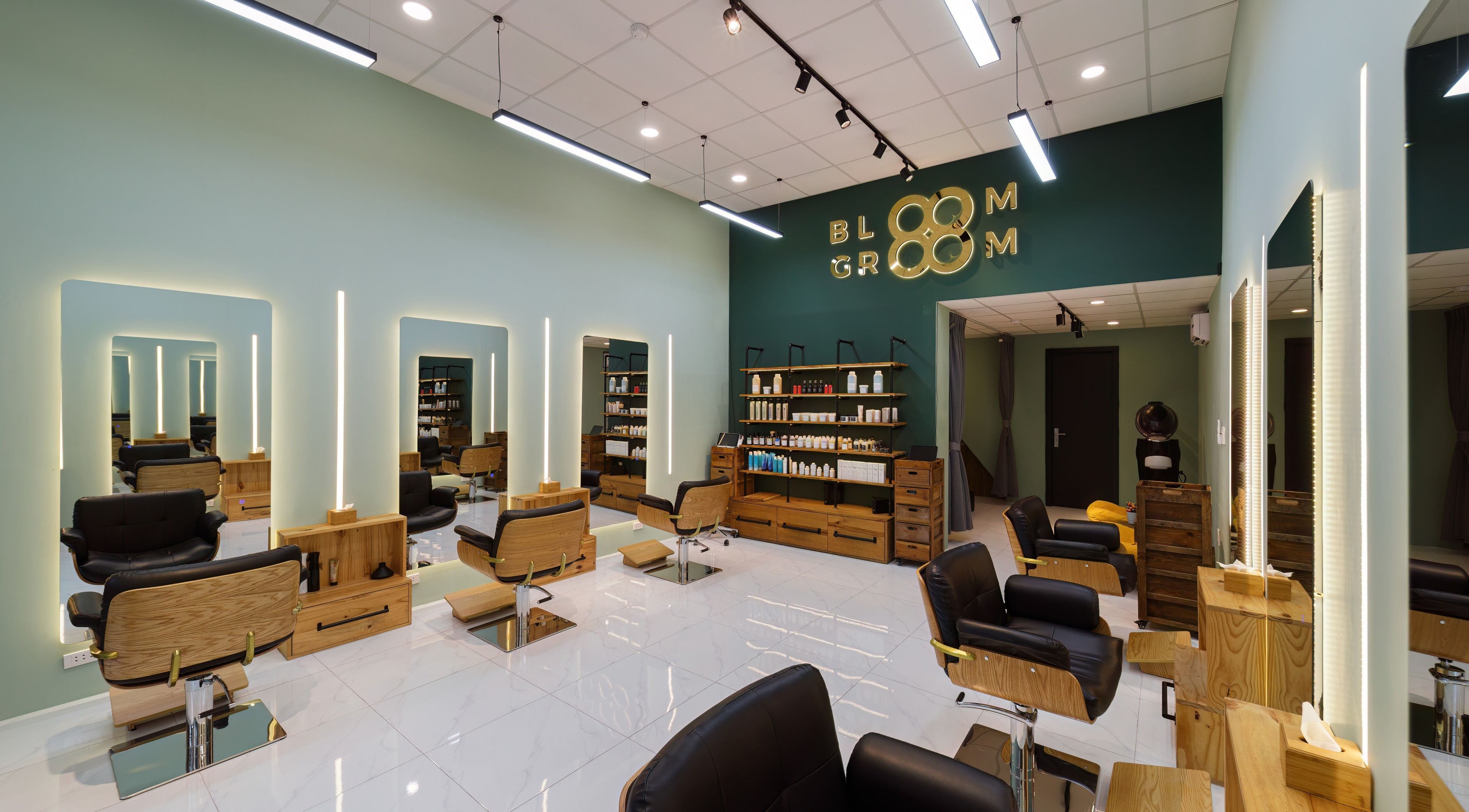Chic interior of Bloom Groom Hair Salon in Hồ Chí Minh, VN showcasing modern chairs and stylish lighting.