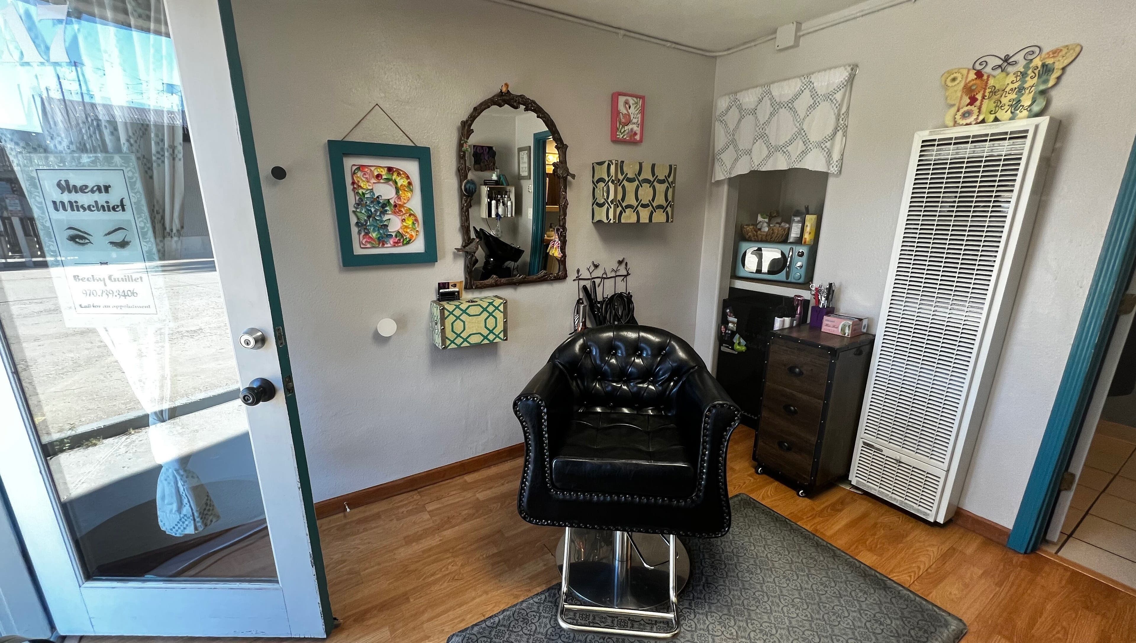 Shear Mischief salon's chic interior with leather chair in Durango, Colorado, US.