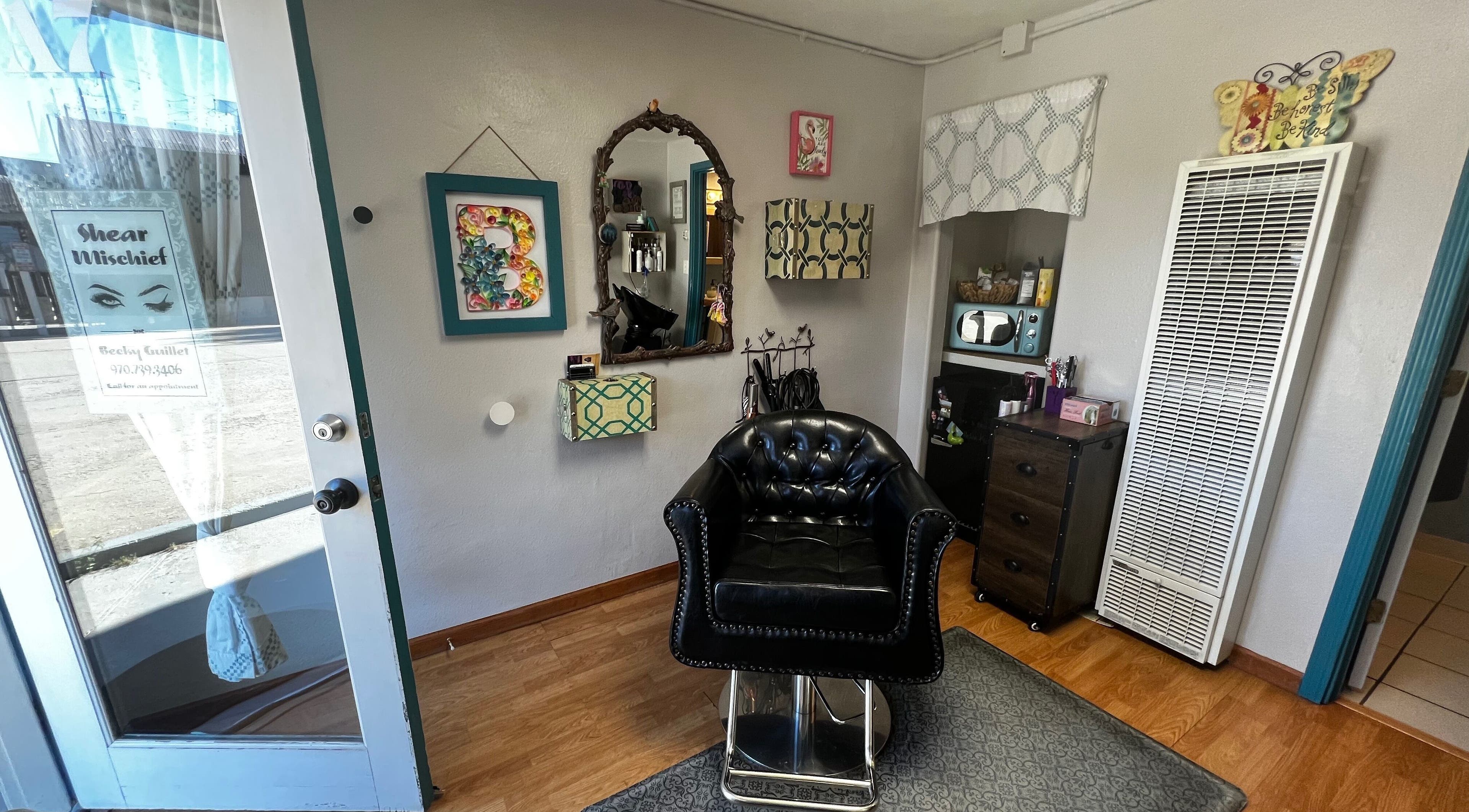 Cozy salon corner with black chair at Shear Mischief, Durango, Colorado, US, showcasing stylish decor.