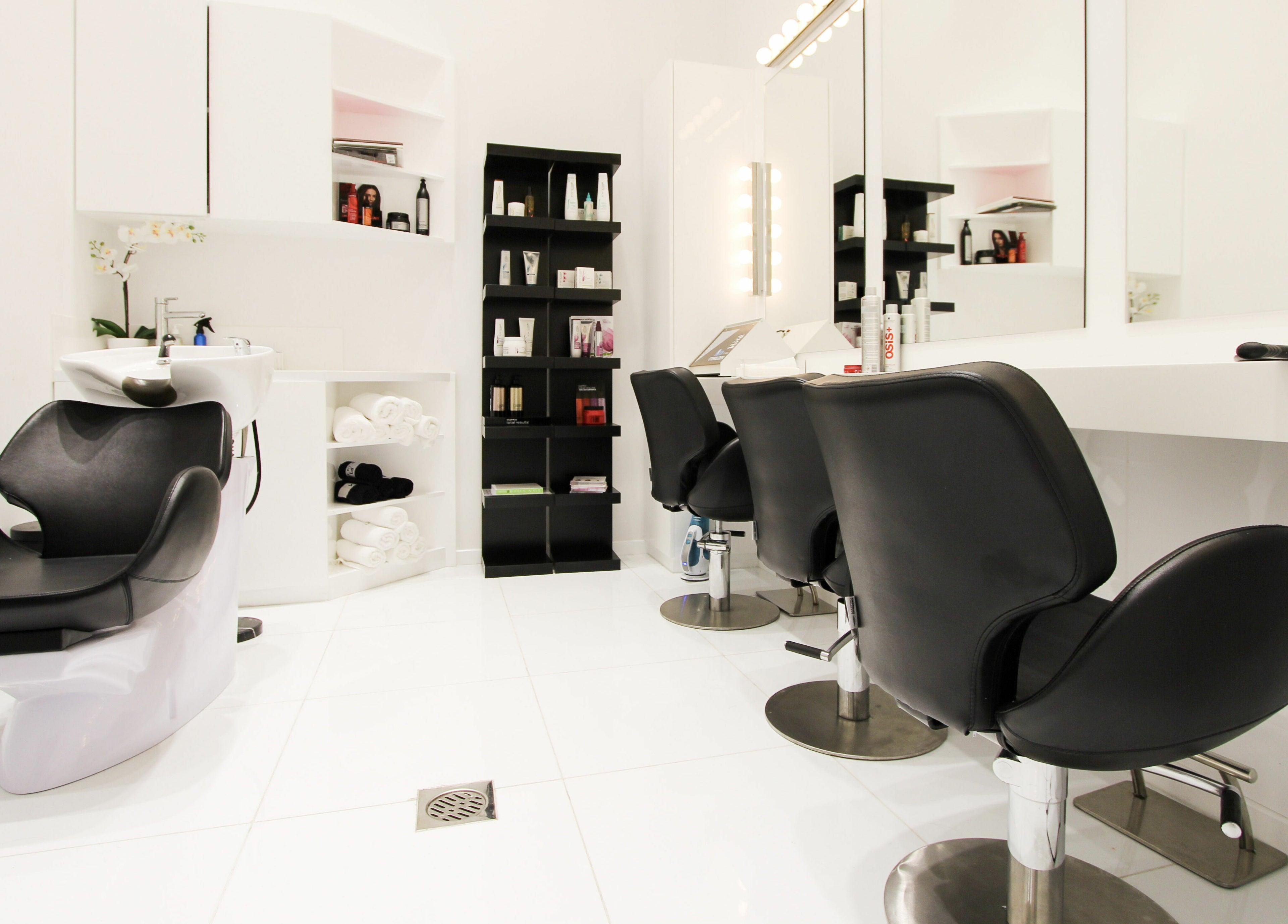 Modern salon interior at Dial A Nail - Palm, Dubai, Dubai, AE with sleek black chairs and beauty products.