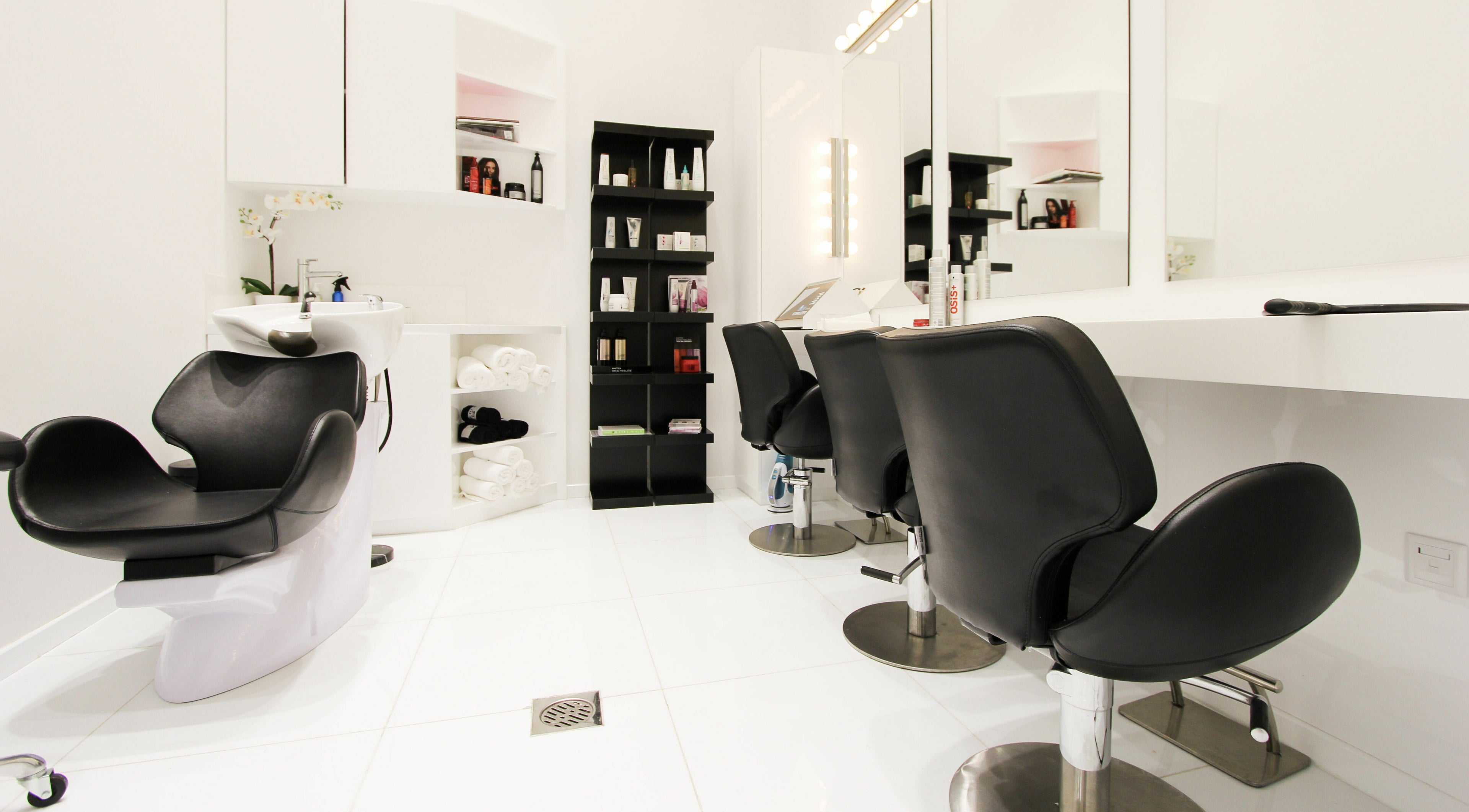 Modern salon interior at Dial A Nail - Palm, Dubai, Dubai, AE with sleek black chairs and beauty products.