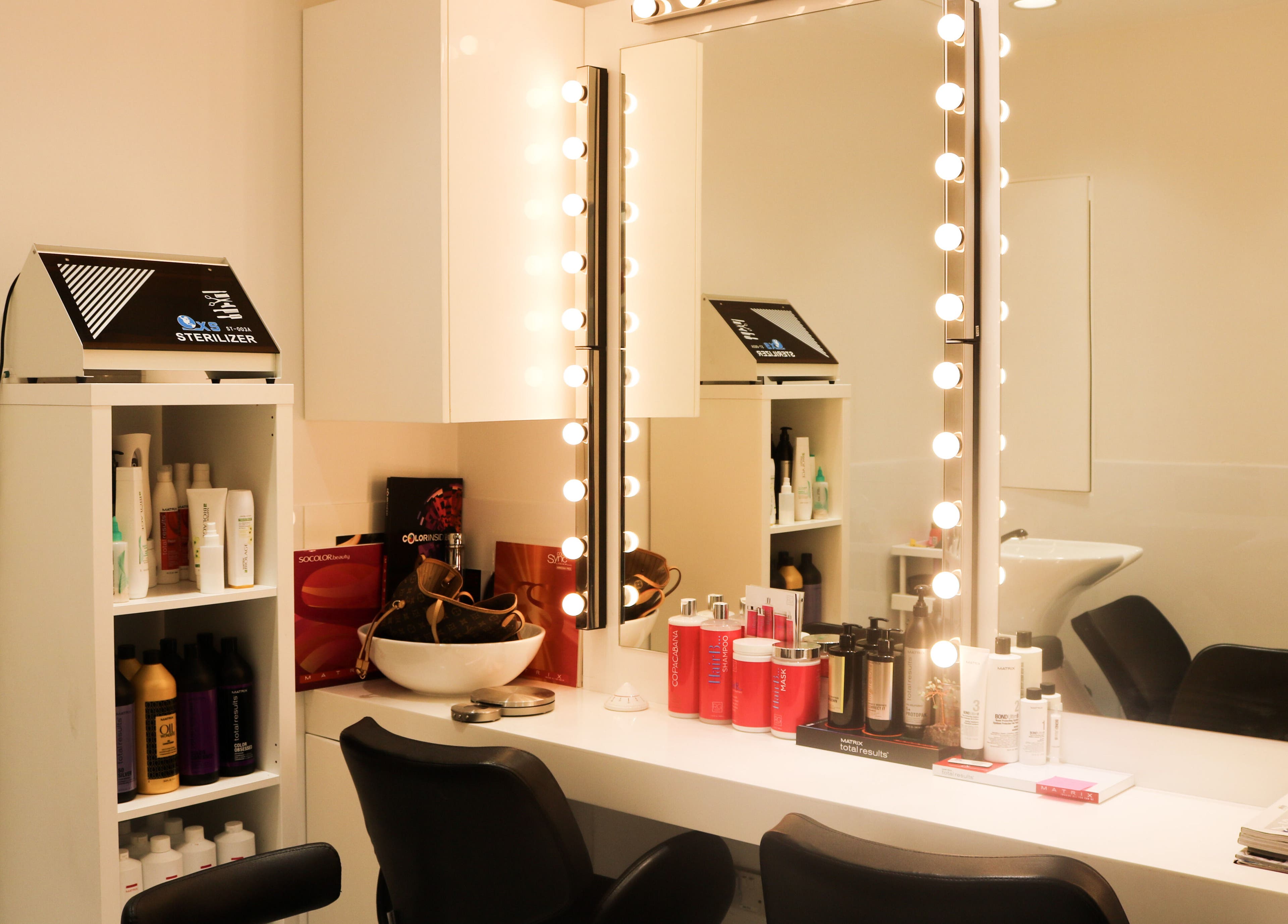 Elegant beauty station at Dial A Nail - Downtown, Dubai, Dubai, AE with illuminated mirror and products.
