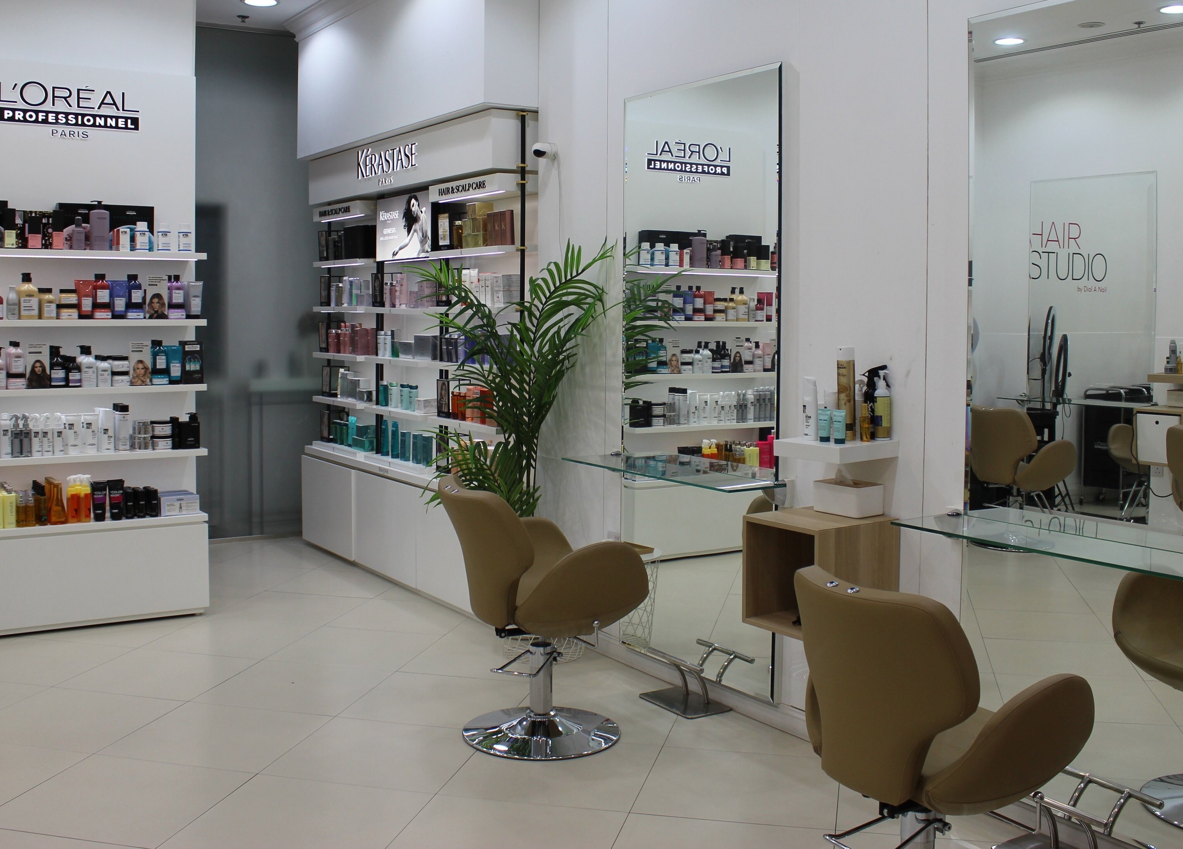 Inside Dial A Nail - Boulevard, Dubai, AE salon with chic seating and shelves of beauty products.