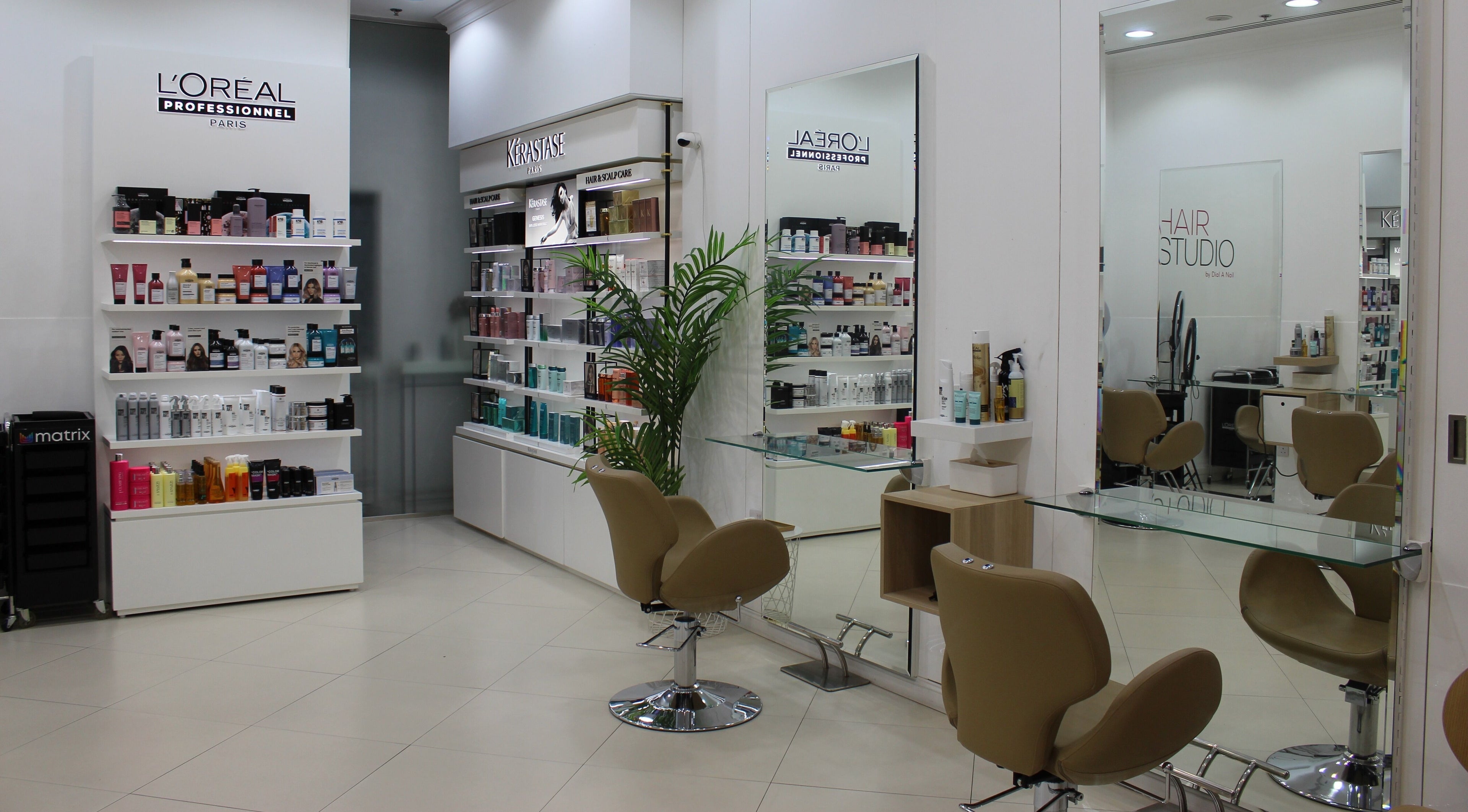 Inside Dial A Nail - Boulevard, Dubai, AE salon with chic seating and shelves of beauty products.