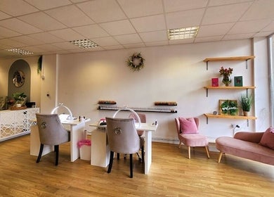 Elegant interior of The Amber Boutique, Milford Haven, Wales, GB, showcasing nail stations and cozy seating.