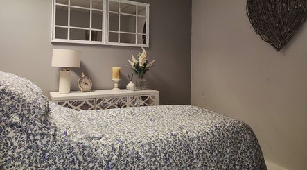 Serene spa room at The Amber Boutique in Milford Haven, Wales, GB with floral decor and calming ambiance.
