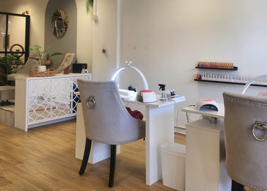 Stylish interior of The Amber Boutique in Milford Haven, Wales, GB, featuring plush chairs and polished nail stations.
