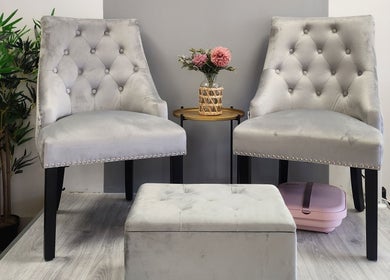 Elegant seating area with plush chairs at The Amber Boutique, Milford Haven, Wales, GB, featuring floral decor.