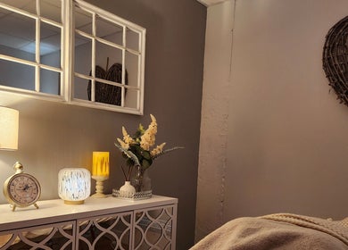 Cozy interior of The Amber Boutique, Milford Haven, Wales with soft lighting, mirrors, and elegant decor.