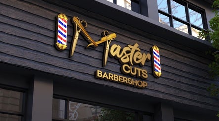 Stylish barbershop sign of Master Cuts in Oshawa, Ontario, CA with golden scissors and barber poles.