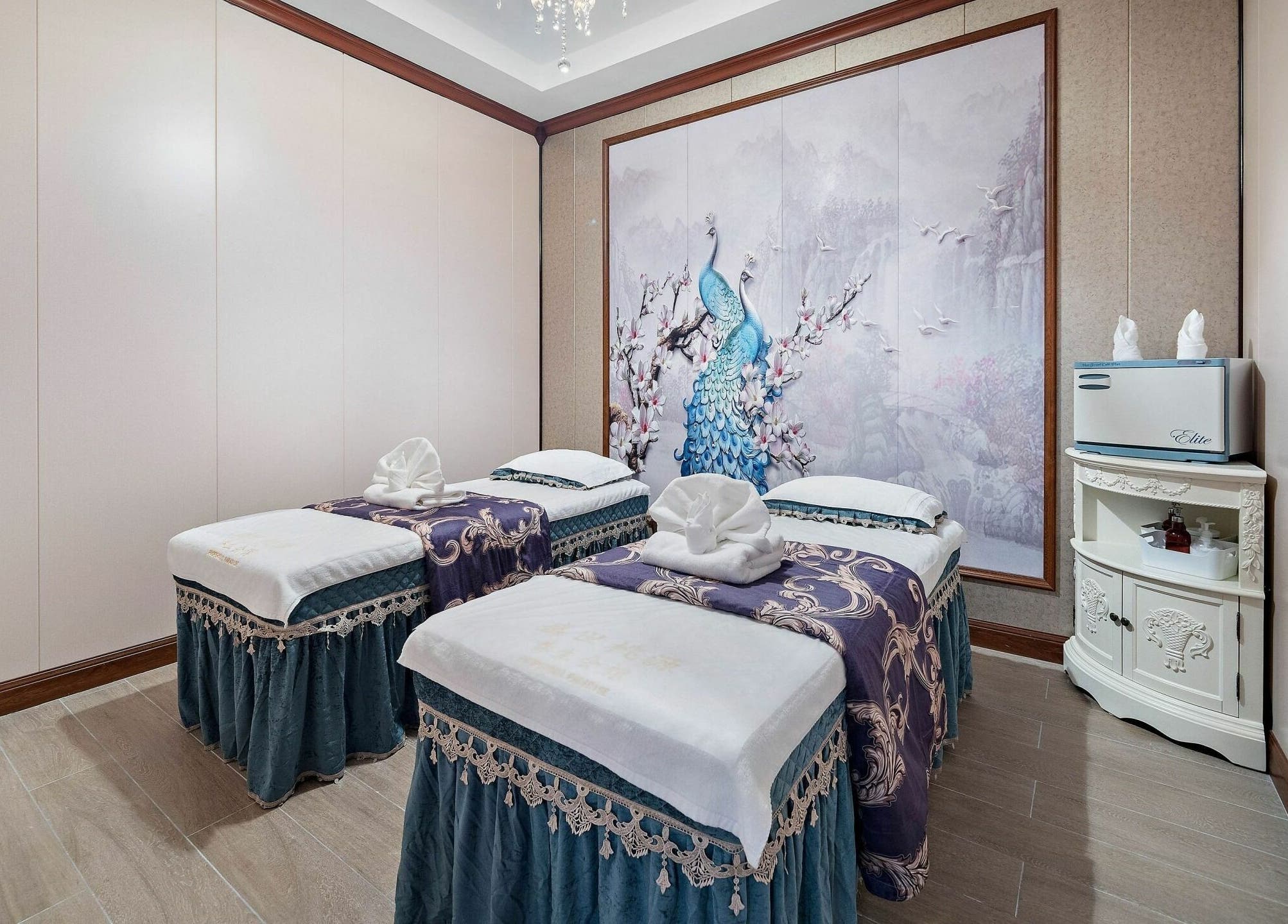 Relaxing dual massage beds at Prosperous Paradise Spa in Houston, Texas, US with elegant peacock artwork.