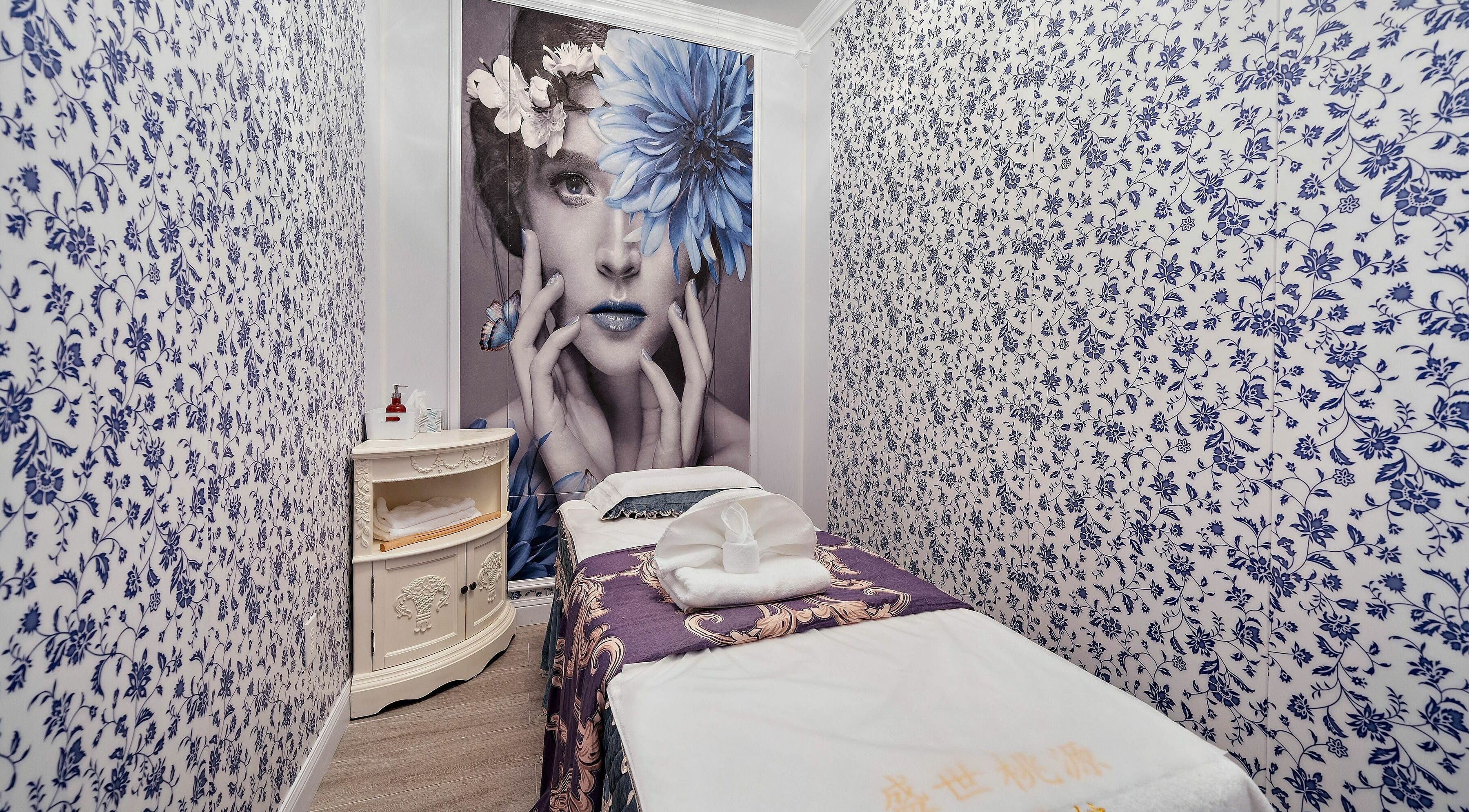Tranquil treatment room at Prosperous Paradise Spa, Houston, Texas, US, with floral decor and plush massage table.
