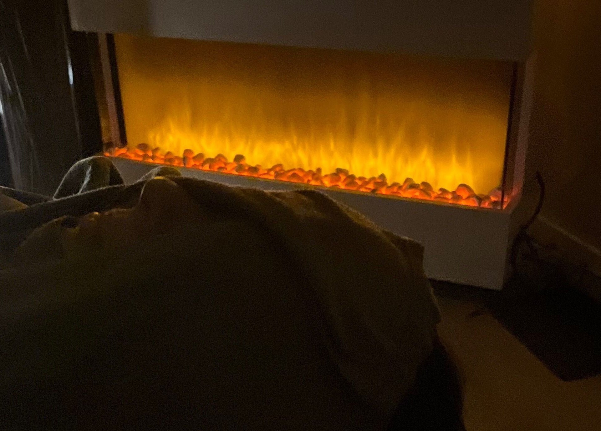 Cozy treatment room with glowing fireplace at Gelous Spa, Calgary, Alberta, CA.