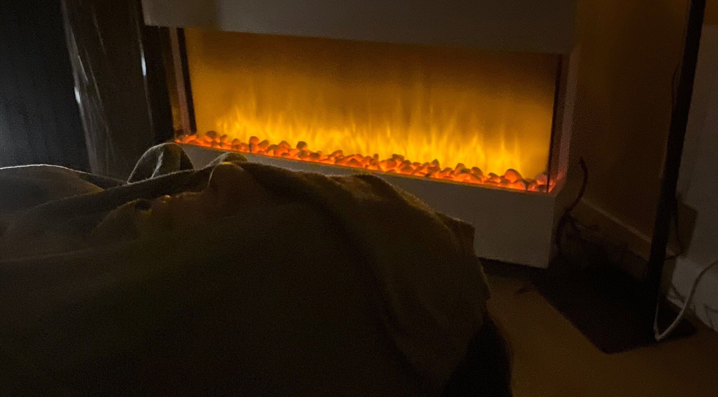 Cozy treatment room with glowing fireplace at Gelous Spa, Calgary, Alberta, CA.