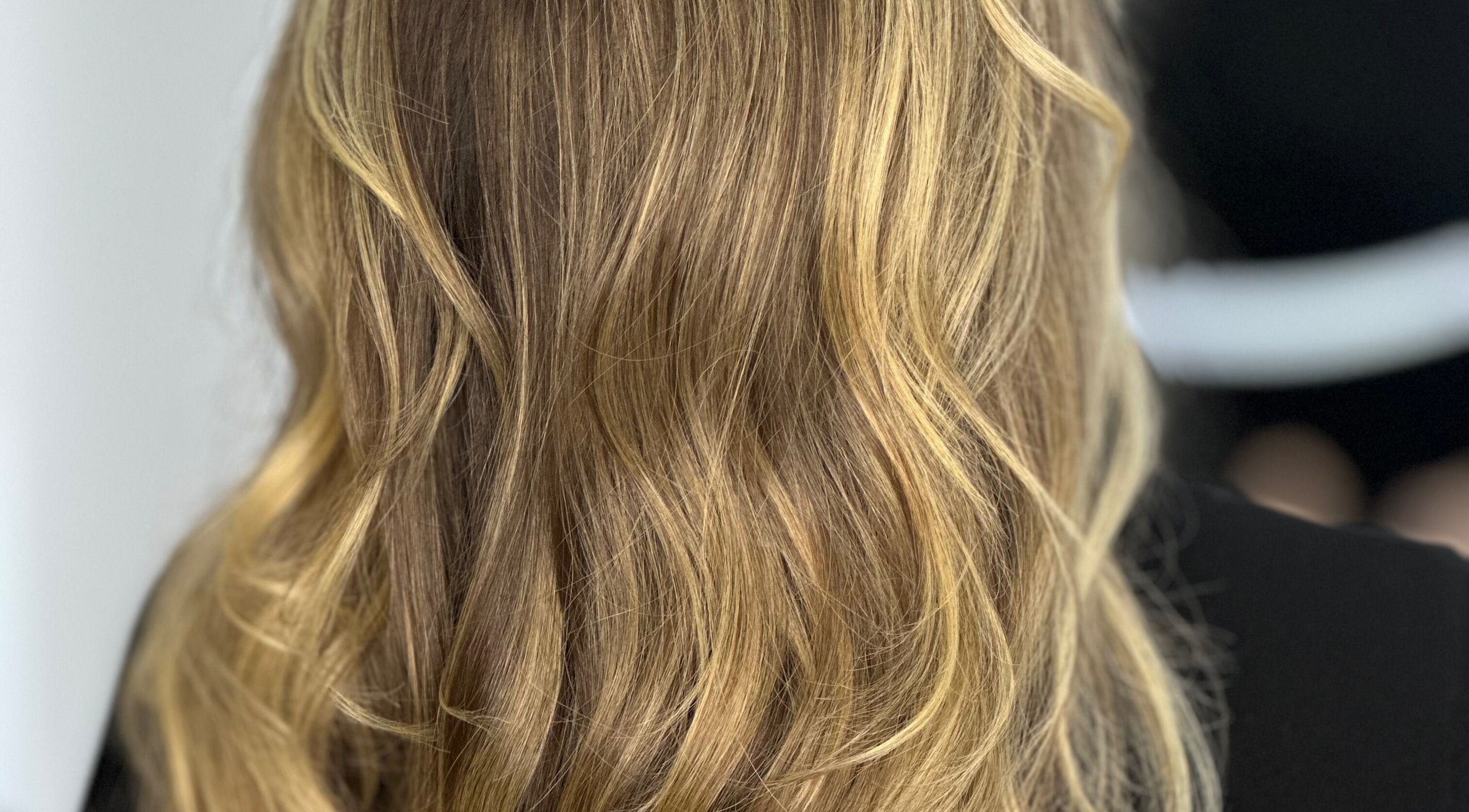 Stylish golden blonde hair with soft waves at Tom Colares Hair Dresser, Dublin, County Dublin, IE.