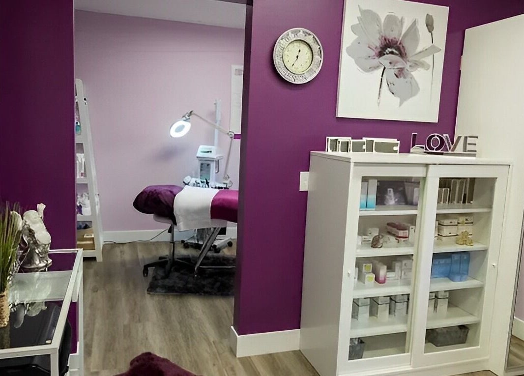 Treatment room at Top Skin Solutions, Sherwood Park, Alberta, CA, with purple accents and beauty products.