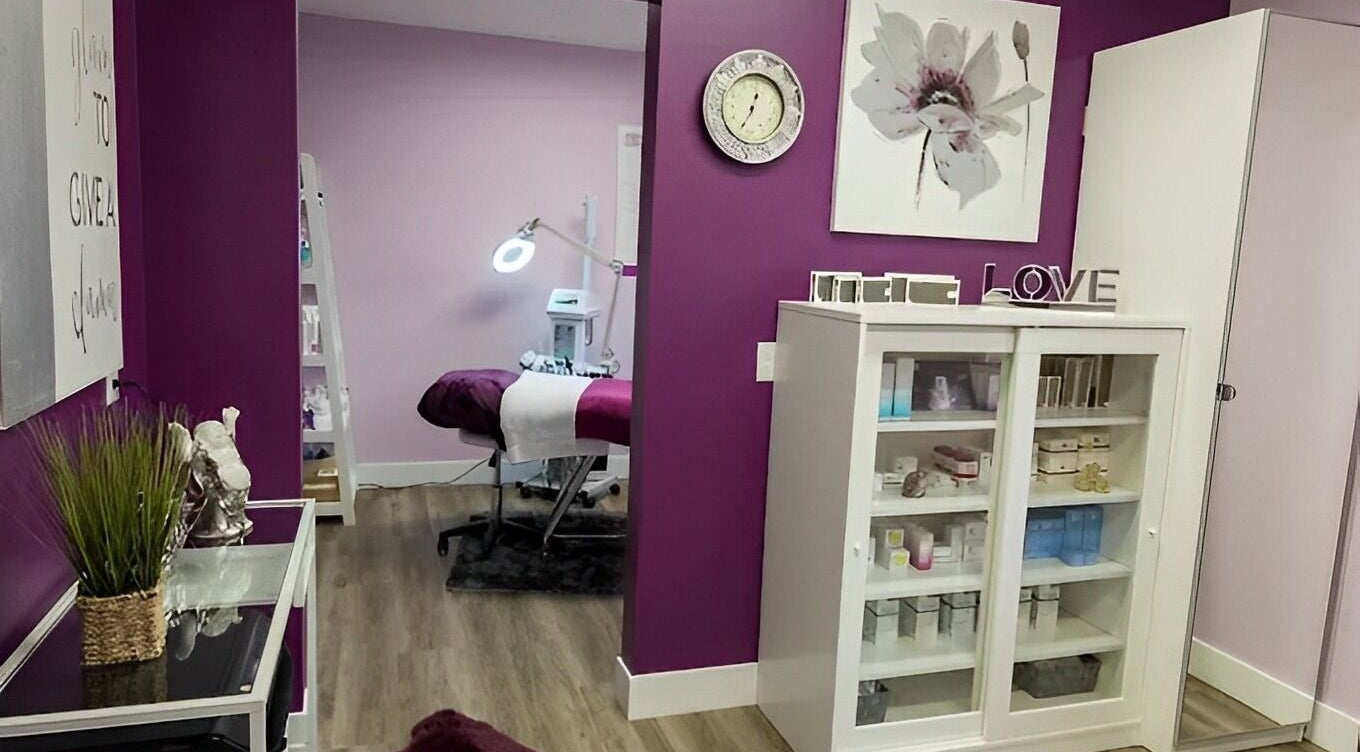 Treatment room at Top Skin Solutions, Sherwood Park, Alberta, CA, with purple accents and beauty products.