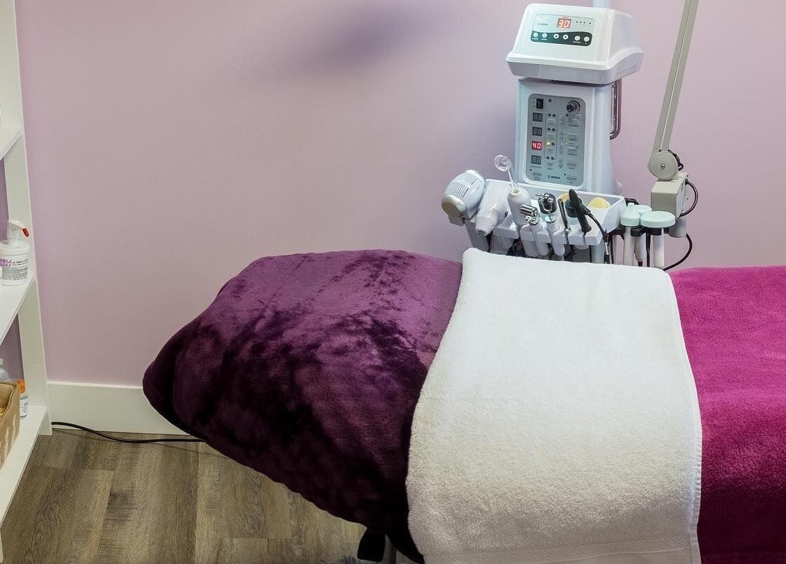 Relaxing treatment room at Top Skin Solutions, Sherwood Park, Alberta, CA with gentle pink decor and modern equipment.
