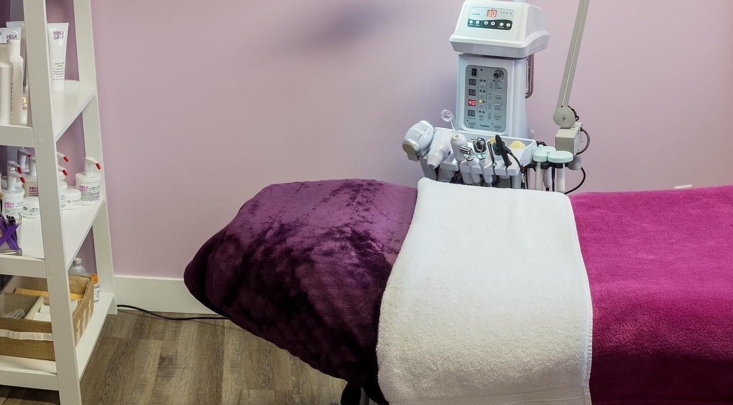 Relaxing treatment room at Top Skin Solutions, Sherwood Park, Alberta, CA with gentle pink decor and modern equipment.