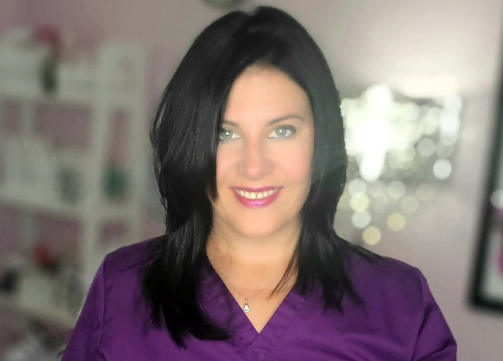 Skincare expert at Top Skin Solutions in Sherwood Park, Alberta, CA, wearing a purple uniform.