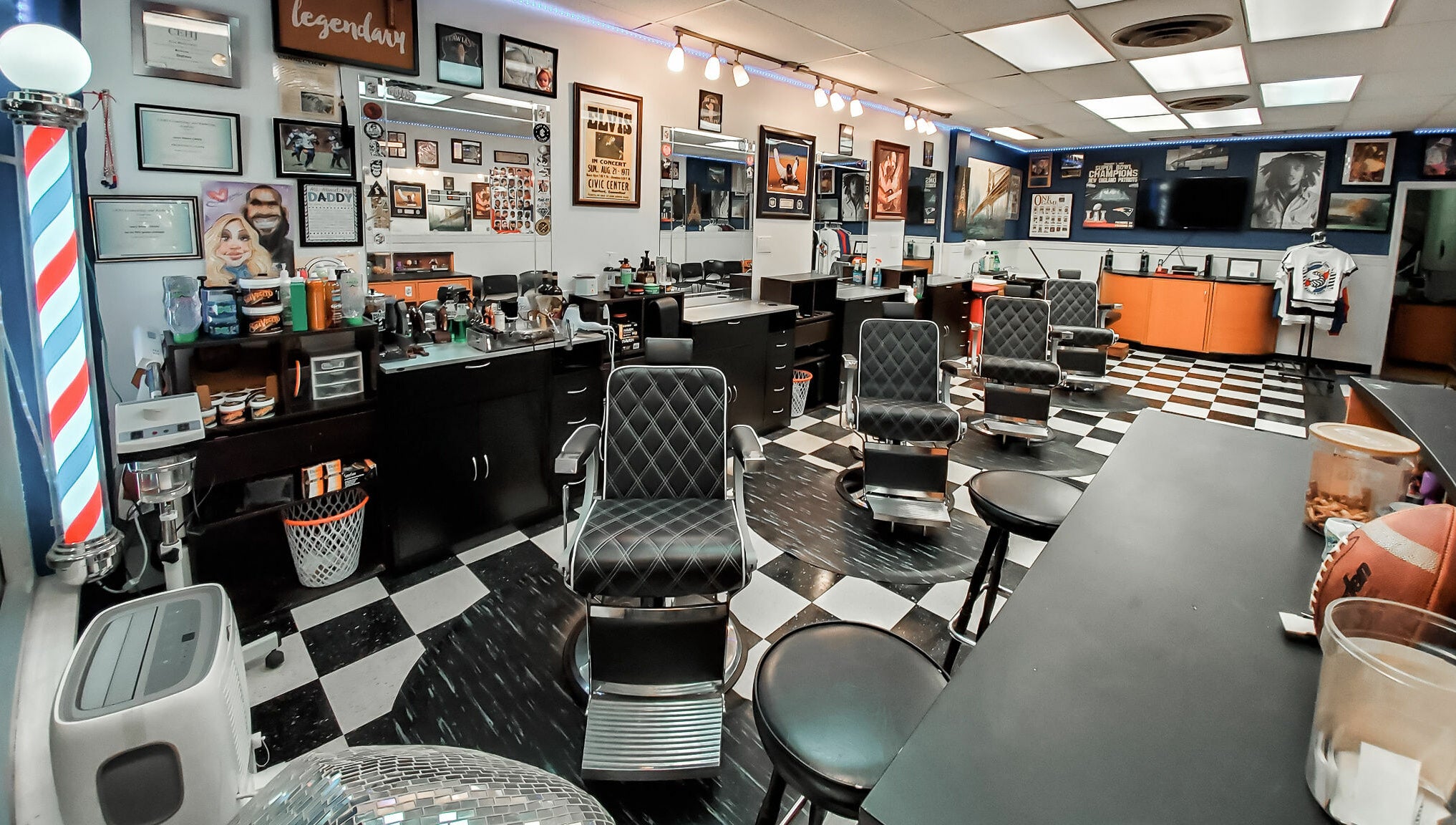 Modern interior of Legendary Looks Barbershop in Vernon, Connecticut, US with stylish barber chairs and decor.