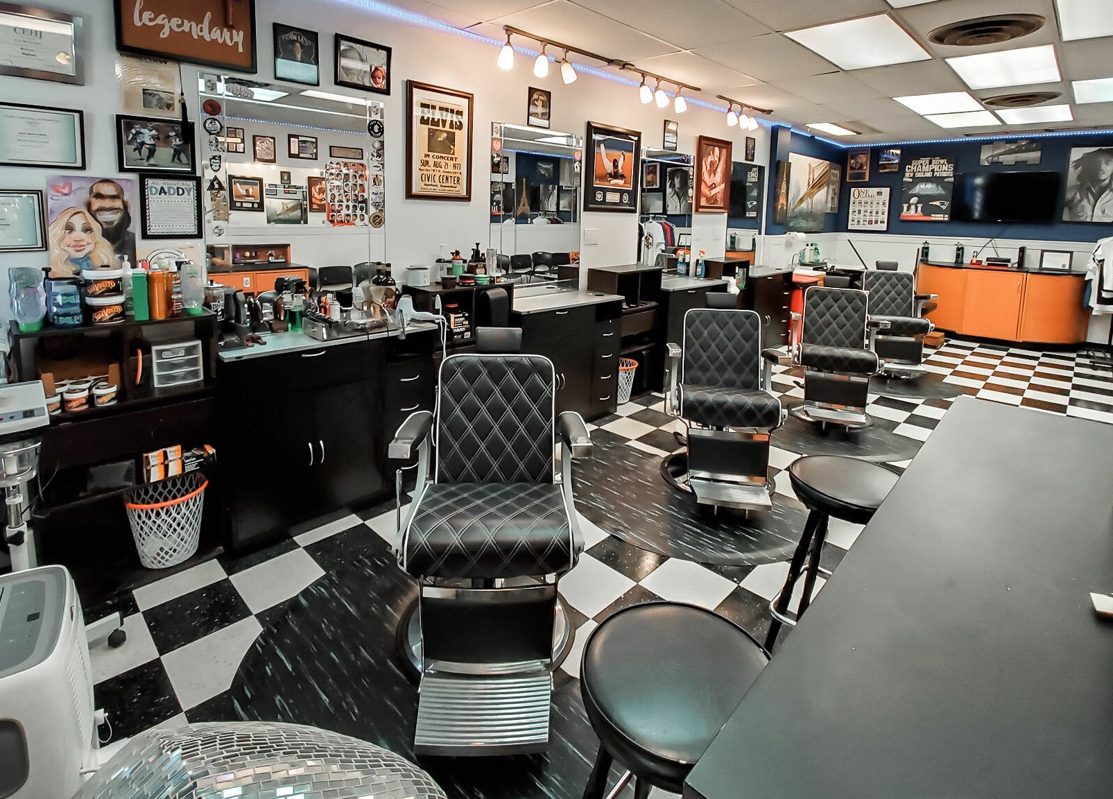 Modern interior of Legendary Looks Barbershop in Vernon, Connecticut, US with stylish barber chairs and decor.