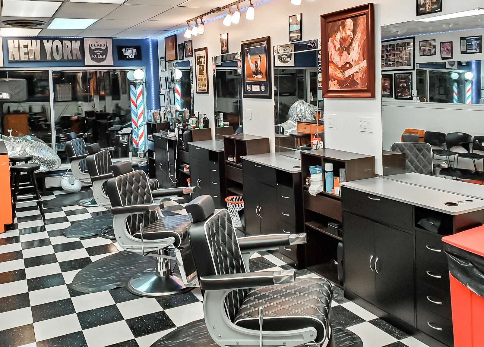 Modern interior of Legendary Looks Barbershop in Vernon, Connecticut, US with sleek black chairs and bright decor.