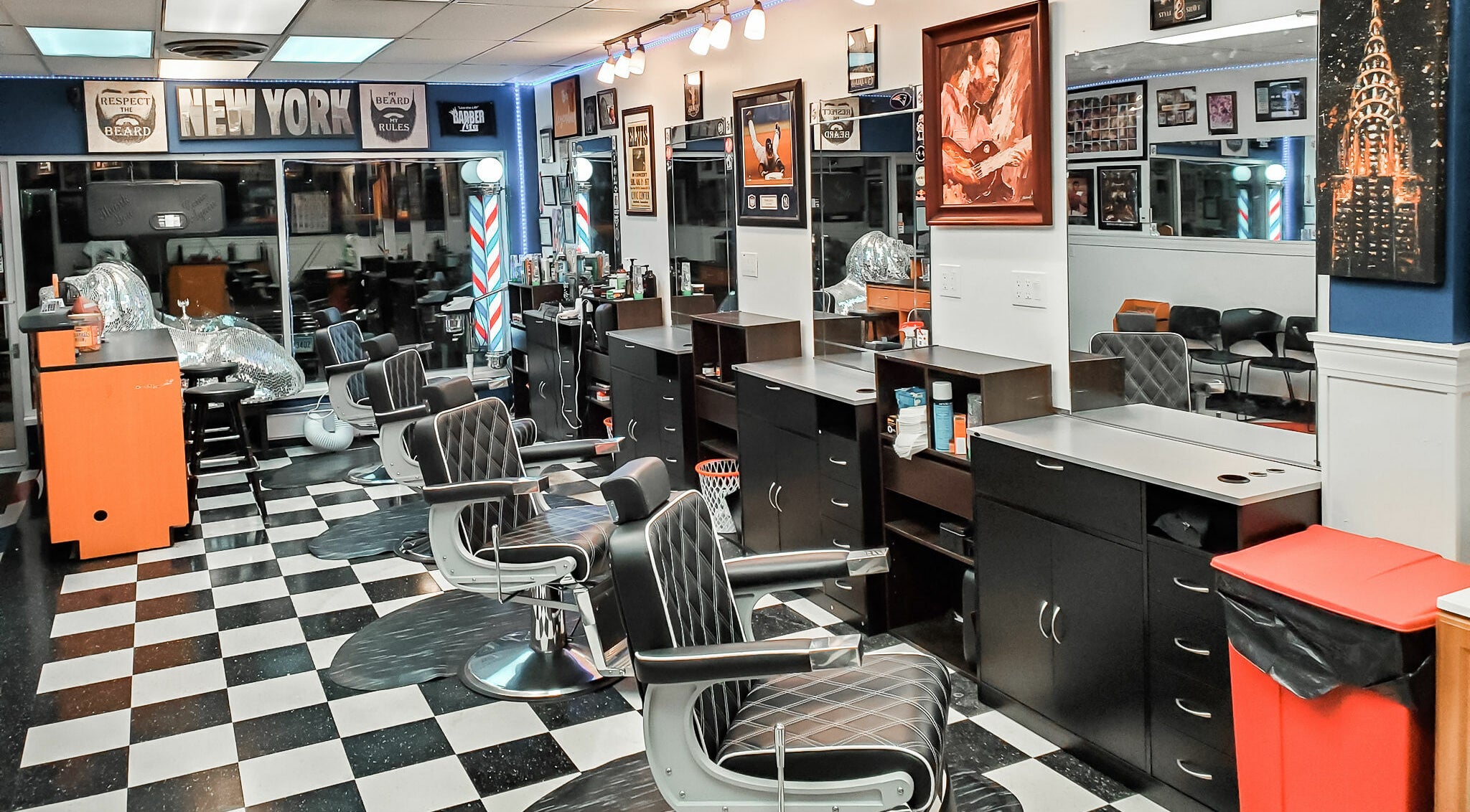 Modern interior of Legendary Looks Barbershop in Vernon, Connecticut, US with sleek black chairs and bright decor.