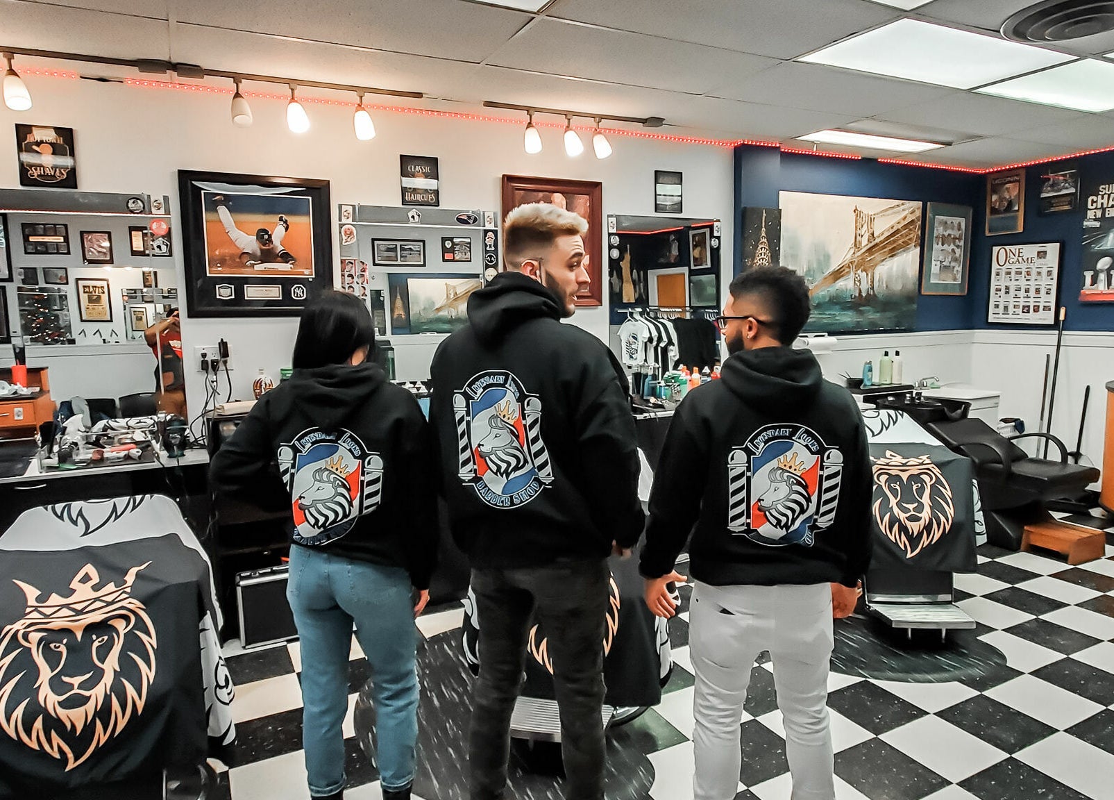 Legendary Looks Barbershop staff posing in branded hoodies in Vernon, Connecticut, US.