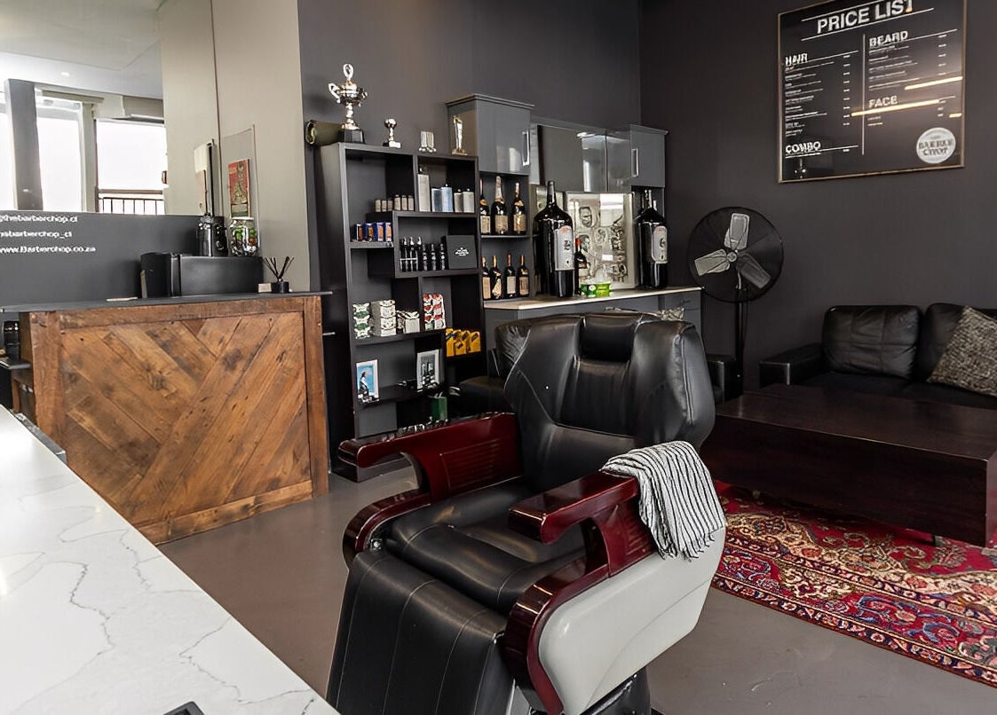 Stylish interior of The Barberchop in Cape Town featuring a modern barber chair and decor.