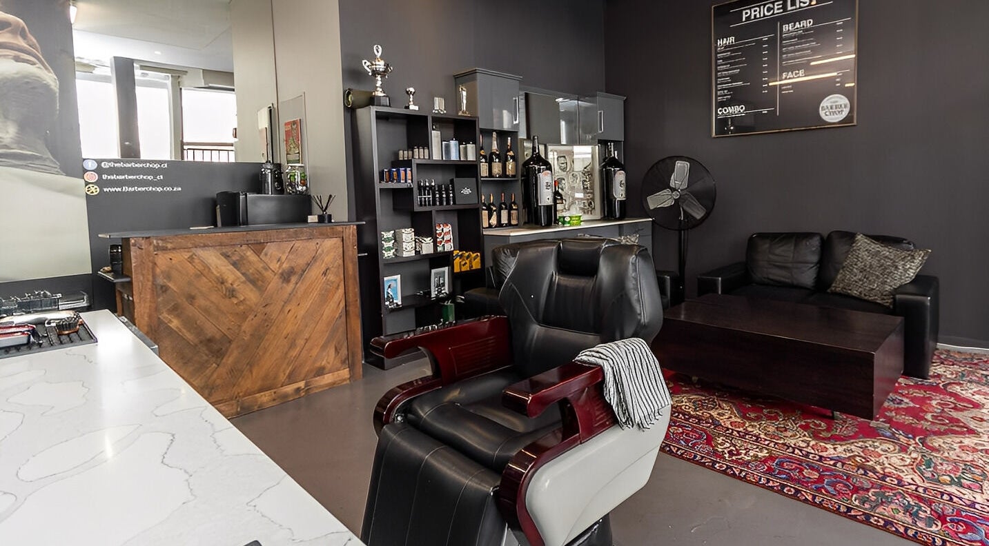 Stylish interior of The Barberchop in Cape Town featuring a modern barber chair and decor.
