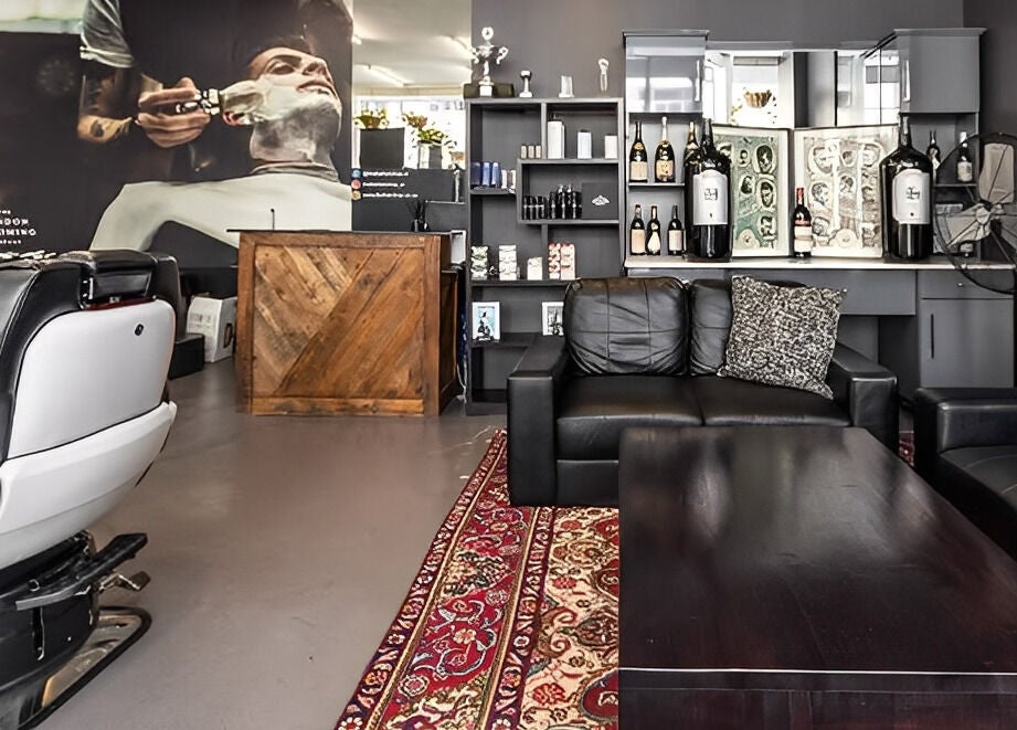 Spacious lounge at The Barberchop in Cape Town, Western Cape, ZA, featuring modern barber chairs and decor.